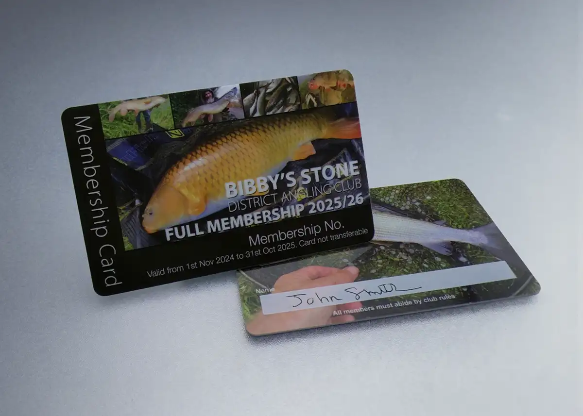a printed plastic card for a angling club with photo of lake