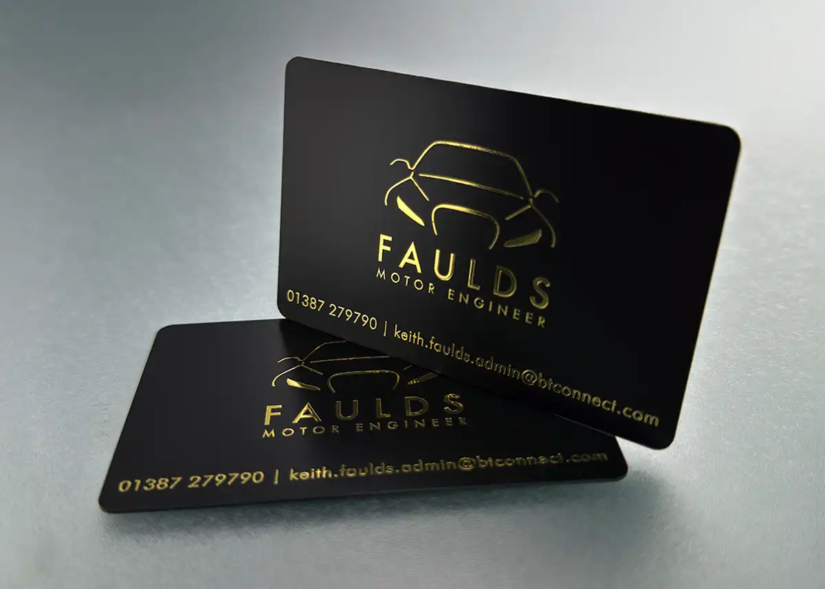 a satin black plastic card printed with metallic gold foil